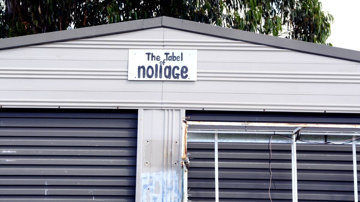 TABLE MANNERS: A group of mates gather every Friday night at this shed at Eglinton for a yarn and a few beers while they solve the problems of the world. The shed has even been given a name – though the spelling is a bit suspect. Photo: PHILL MURRAY 032014psnap