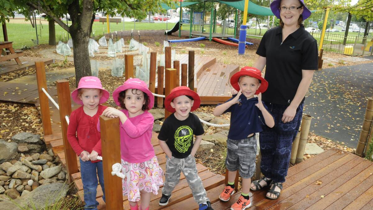SNAPPED: Sophia Tolhurst, Holly Wilkinson, Phoenix Vella and Cooper Healey from Scallywags Child Care Centre headed outdoors with 032614cgarden