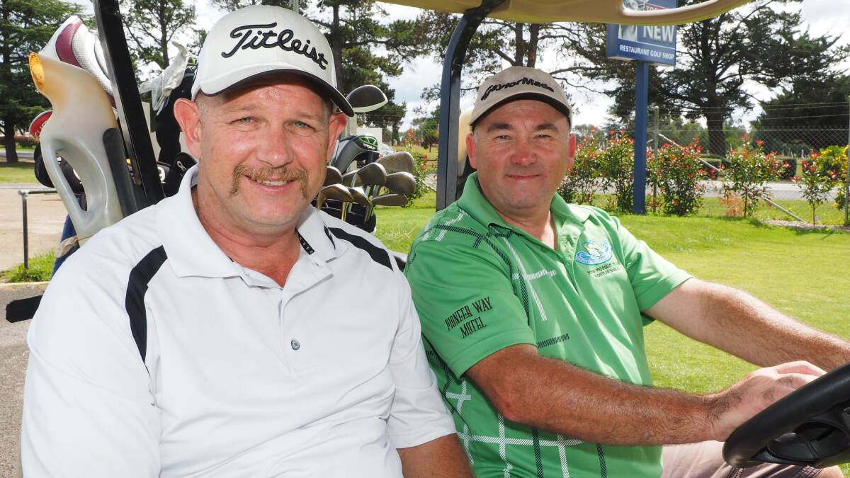 OUT AND ABOUT: Peter Robbins and Mark Mountain enjoy a social game of golf. 032314zgolf1