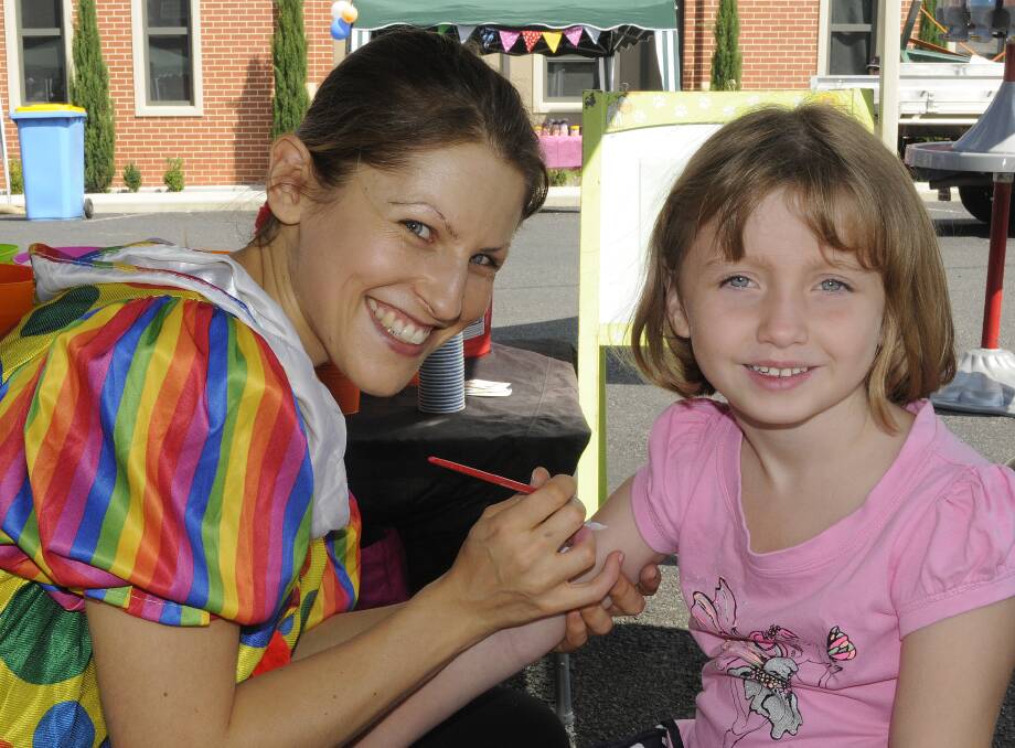 SNAPPED: St Michael and St John’s Cathedral community fete. Agnieszka Krysiak with Imogen Smith, 5. 033014cath2