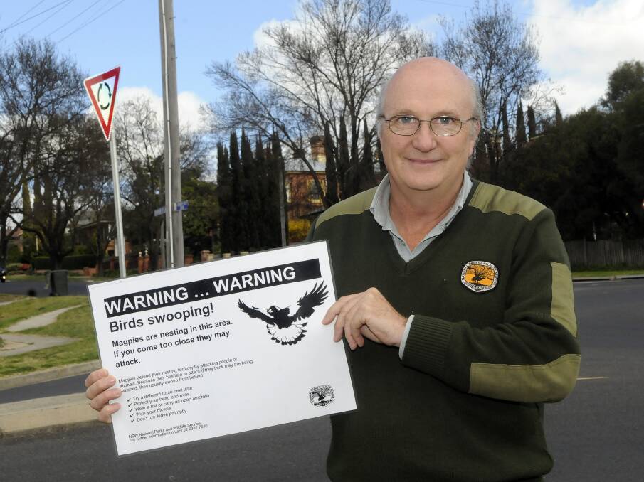 WEALTH OF EXPERIENCE: National Parks ranger Steve Woodhall with a magpie aware sign. Steve Woodhall will be speaking about his 30 years experience to help mark World Ranger Day. 