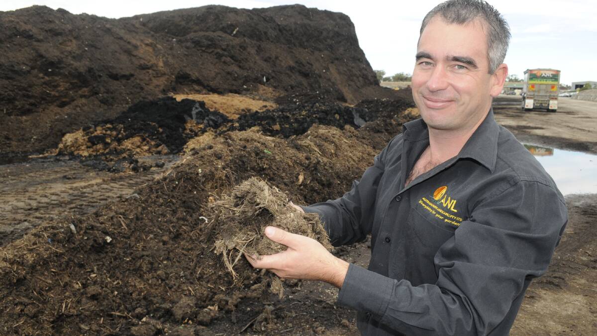 MAKING COMPOST: Jason White, ANL Central West’s regional manager, with shredded matter from the compost screening area. Photo: CHRIS SEABROOK 	050216cgreenw3