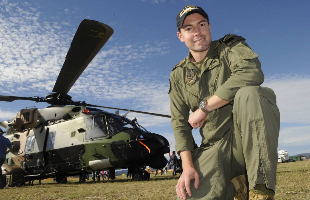 DEFENCE SUPPORT: Royal Australian Navy pilot Lieutenant Lachlan Badger, a pilot with 808 Squadron, said the Royal Australian Navy’s MRH-90 Taipan was a hit with the crowd at yesterday’s Soar Ride and Shine event held at Bathurst Airport. Photo: CHRIS SEABROOK 051516cairshw1