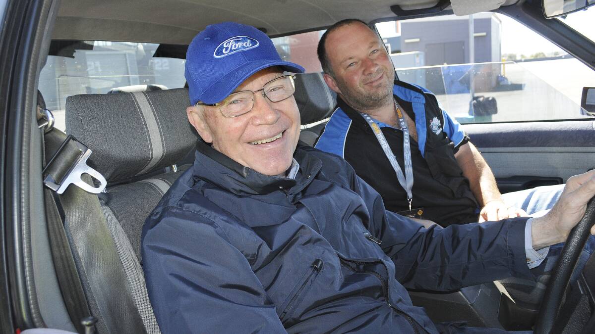 COOL SPIN: Motorsport legend Allan Moffat took race fan Dion Italiano for a spin around Mount Panorama yesterday as a fundraiser for the Leukaemia Foundation. Photo: CHRIS SEABROOK. 110214cmoffat1