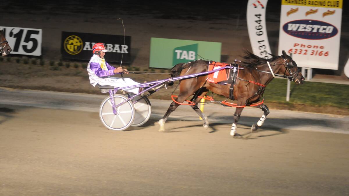 READ ALL ABOUT IT: Georges Plains trainer-driver Bernie Hewitt wins the Gold Bracelet Final at the Bathurst Paceway with Read About Lexy. Photo: CHRIS SEABROOK	 032815cbraclt1a