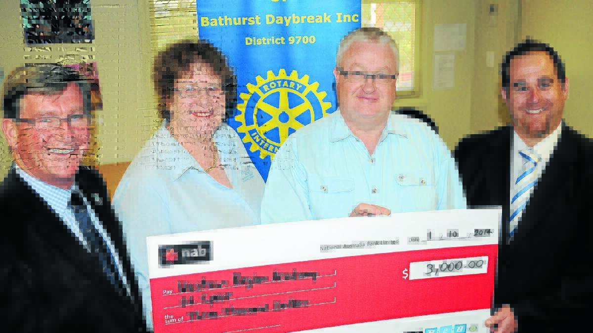 DEVELOPING YOUNG CYCLISTS: Bathurst Mayor Gary Rush, Nancy Haslop (Western Region Academy of Sport), Craig Ronan (Rotary Club of Bathurst Daybreak) and Tim Brown (NAB) with a cheque for $3000 which will fund a cycling camp for talented young riders. Photo: CHRIS SEABROOK 	100114cwras