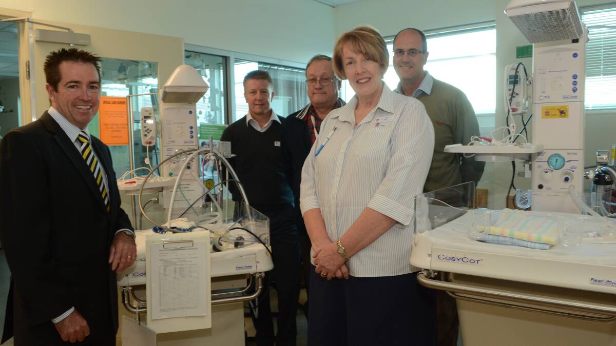 SAVING LIVES: Bathurst MP Paul Toole, nursing and midwifery director Bradley Molenkamp, paediatrician Dr Tim McCrossin, midwifery nursing unit manager Rene Sharp and Bathurst Base Hospital general manager David Wright with the new resuscitation cots. Photo: PHILL MURRAY	 050914pinfant
