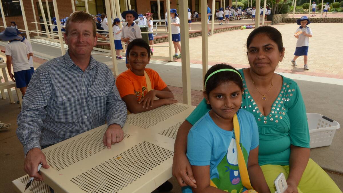 REUNITED: Ramya Ranaweera can’t thank everyone enough for bringing her children to Australia and helping with the big transition. From left, St Philomena’s principal James Farr with Shenal Breden, Deina Shenoni and Ramya Ranaweera. Photo: PHILL MURRAY	 111914pstphils