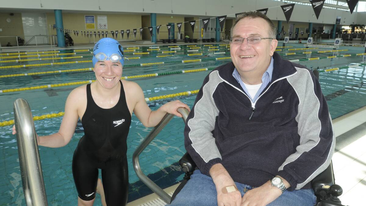 MAKING A SPLASH: Rachel Staines, who is receiving plenty of support in her push to go to the Rio de Janeiro Paralympic Games, and her father Allan at the Bathurst Aquatic Centre. Photo: CHRIS SEABROOK 	071813crachel3