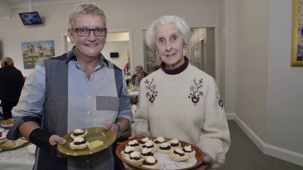 MORNING TEA: Noreen Munson is served some homemade scones by Daffodil Cottage
volunteer Gen Croaker at yesterday’s Biggest Morning Tea. Photo: PHILL MURRAY	 052716ptea5