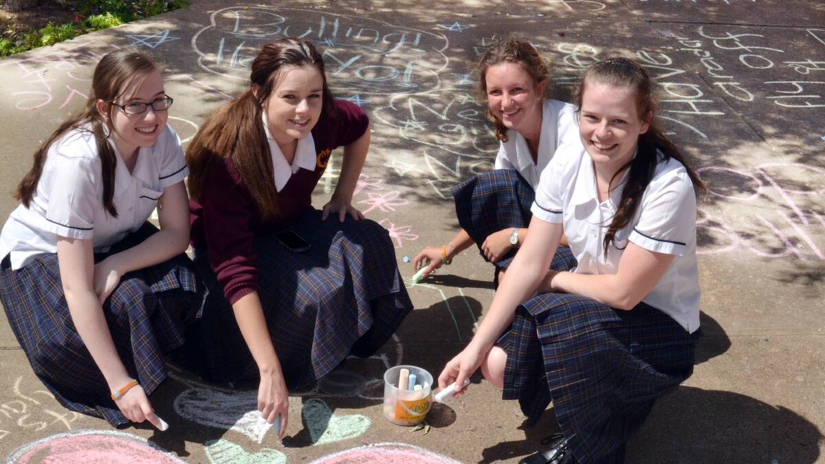 SPREADING THE MESSAGE: MacKillop College Year 12 students Grace Brouggy, Gabby Boylan-Smith, Sarah Barlow and Rebekah Casey getting creating with the anti-bullying message. Photo: KATE BURKE 	032114bully2