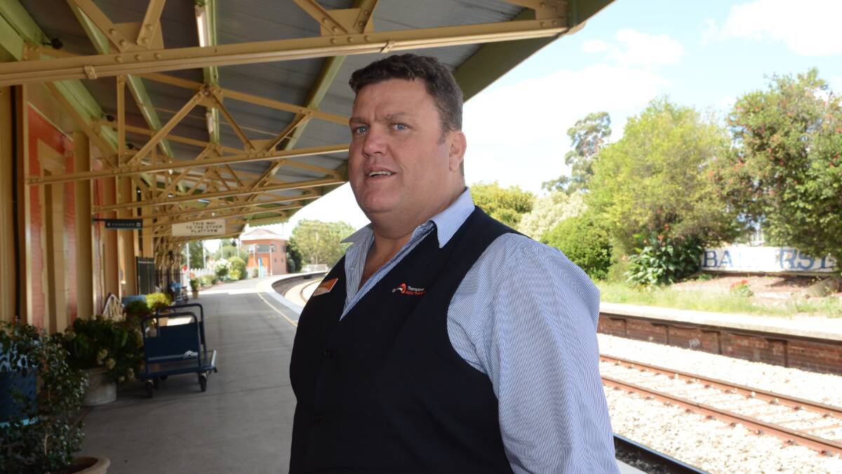 JUMP ABOARD: Bathurst Train Station senior customer attendant Anthony Bray is one of a team of people ensuring a smooth passage for people jumping aboard the popular Bathurst Bullet. 
Photo: PHILL MURRAY 	012915panthony