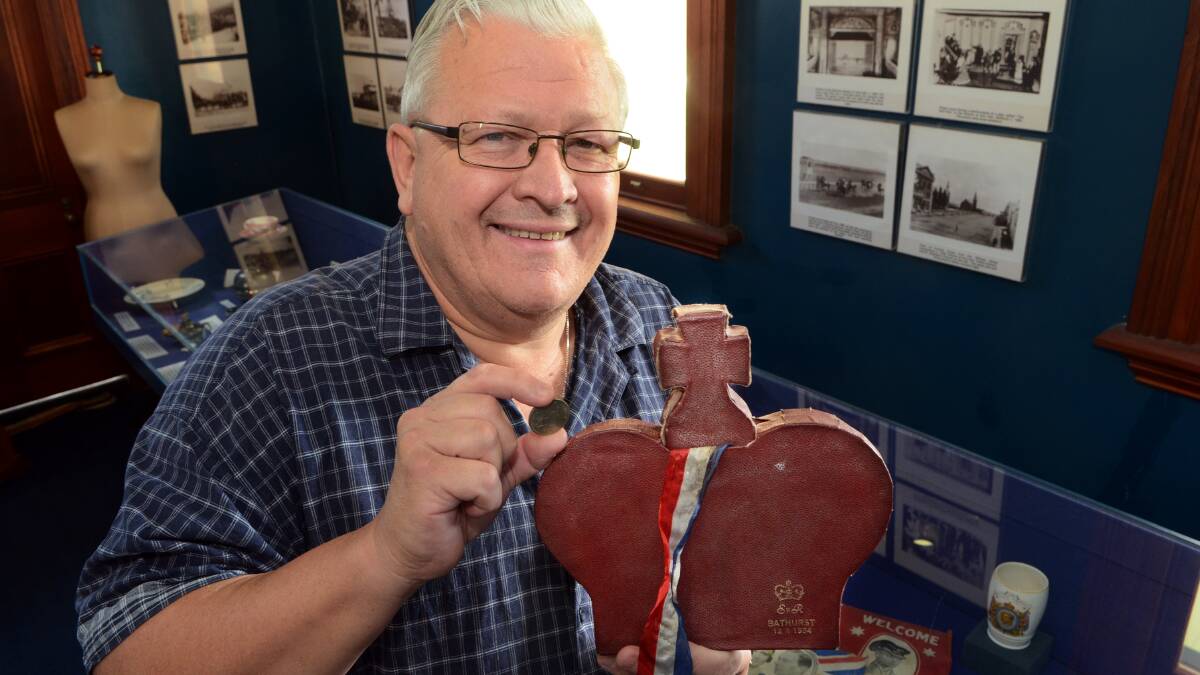 ROYAL FEVER: Bathurst Historical Society president Alan McRae with a box and a two shilling coin commemorating Queen Elizabeth II’s 1954 visit. 	041614proyal
