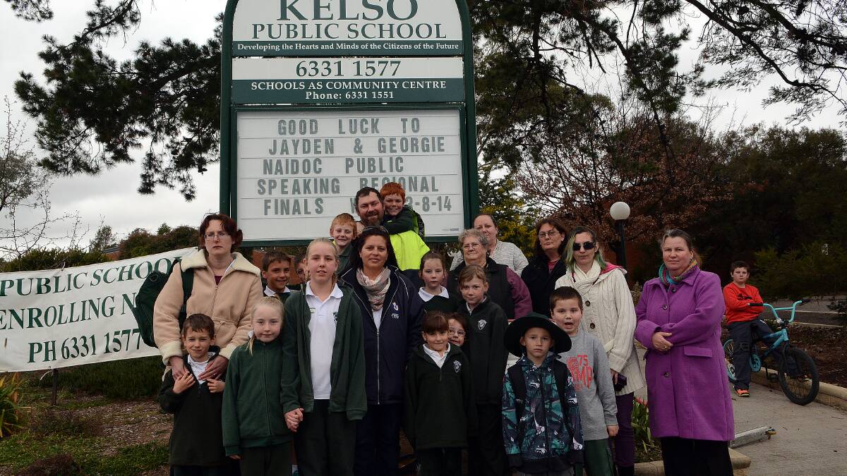 WE STILL NEED A FENCE: Parents and students outside Kelso Public School after last weekend’s vandalism. While they are happy with news of a security upgrade, the parents still want a fence around the school.  Photo: PHILL MURRAY 	081214pkelso