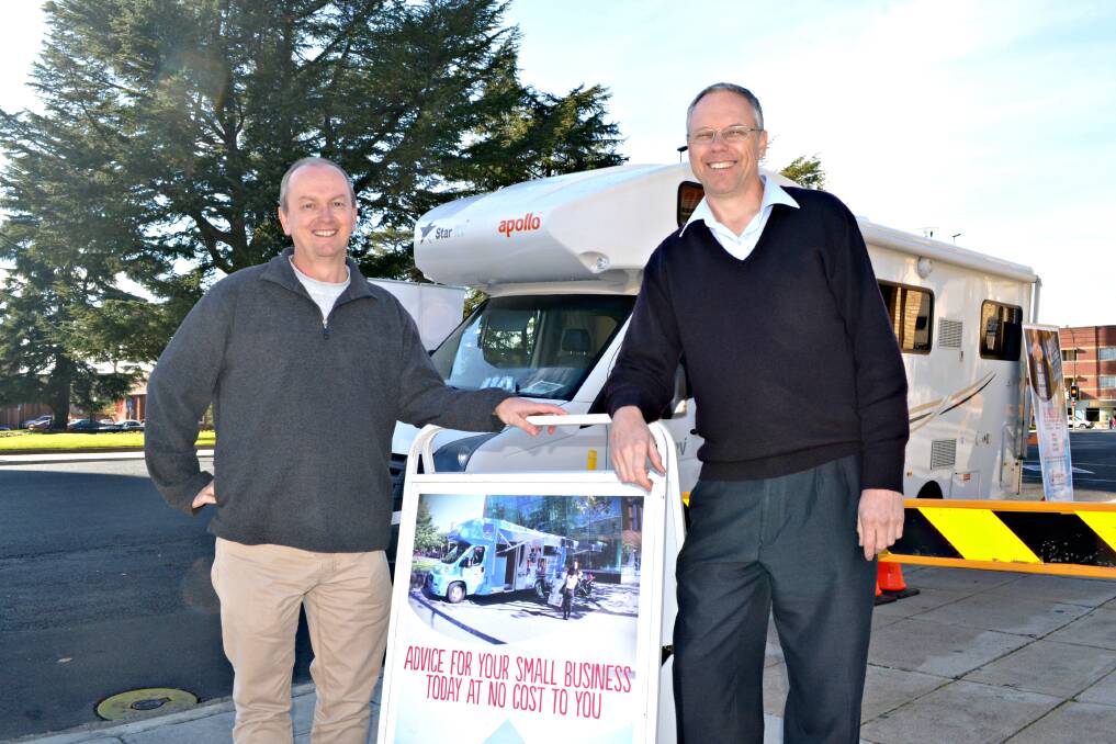 OPEN FOR BUSINESS: Bathurst Observatory Research Facility owner Ray Pickard, pictured with small business advisor Russell Meadley, was one of the many people who took advantage of the Small Biz Bus on its first day of its visit to Bathurst. Photo: RACHEL FERRETT 	052715rfbizbus