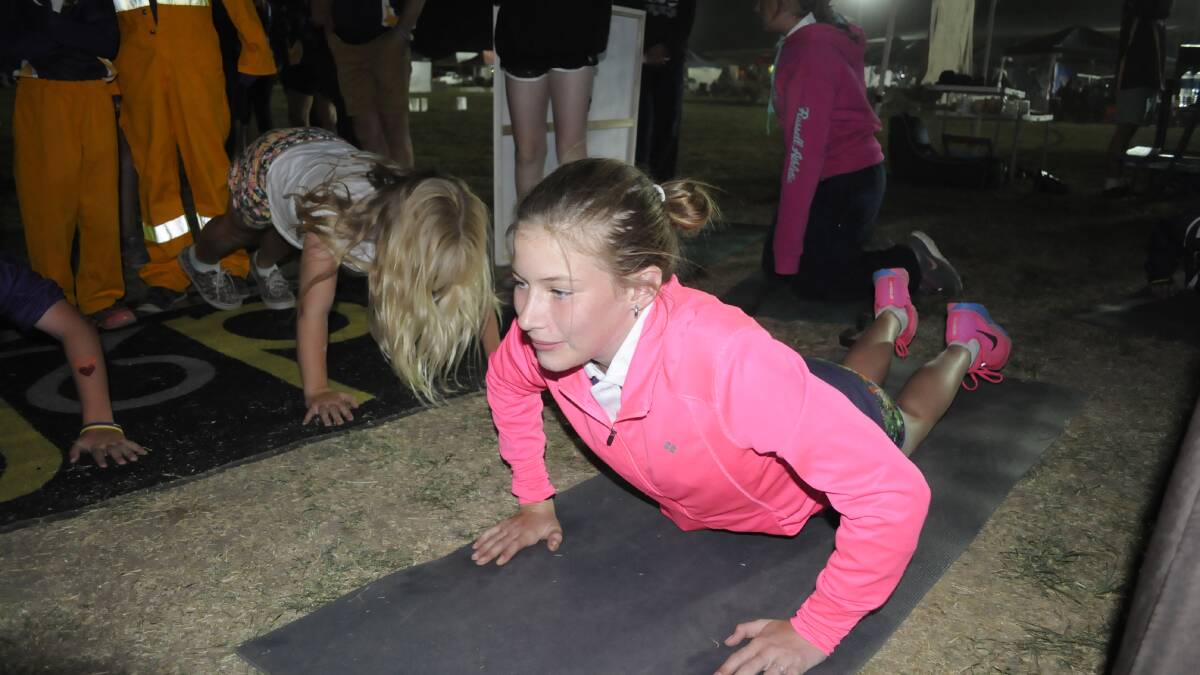 SUCCESS: Charley Fitzpatrick put in 35 push ups on Saturday night to help Dedicated to Fitness (d2f) reach its target of 100,000 for the fundraiser. Photo: CHRIS SEABROOK. 	031415crelay2