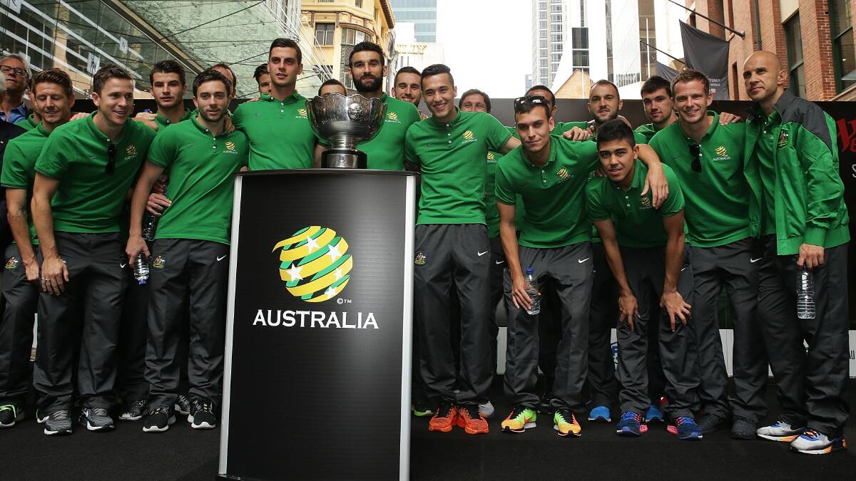 CHAMPIONS: The Socceroos squad, including Blayney’s Nathan Burns (far left), after their win in the Asian Cup final on Saturday night. 	020115soccer