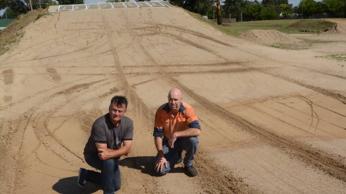 LINE IN THE SAND: Bathurst BMX Club president Michael Breen and secretary Greg Westman are fed up with vandals driving on the club’s River Road track and leaving deep tyre marks that make it unsafe for riders. Photo: PHILL MURRAY 	022715pbmx1