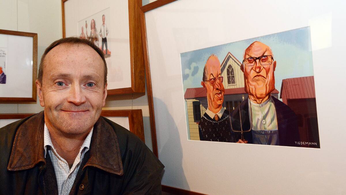 AUSTRALIAN GOTHIC: Bathurst Regional Council collections manager Tim Pike with his pick of John Tiedemann’s take on “American Gothic”. Photo: PHILL MURRAY 	071114ptim