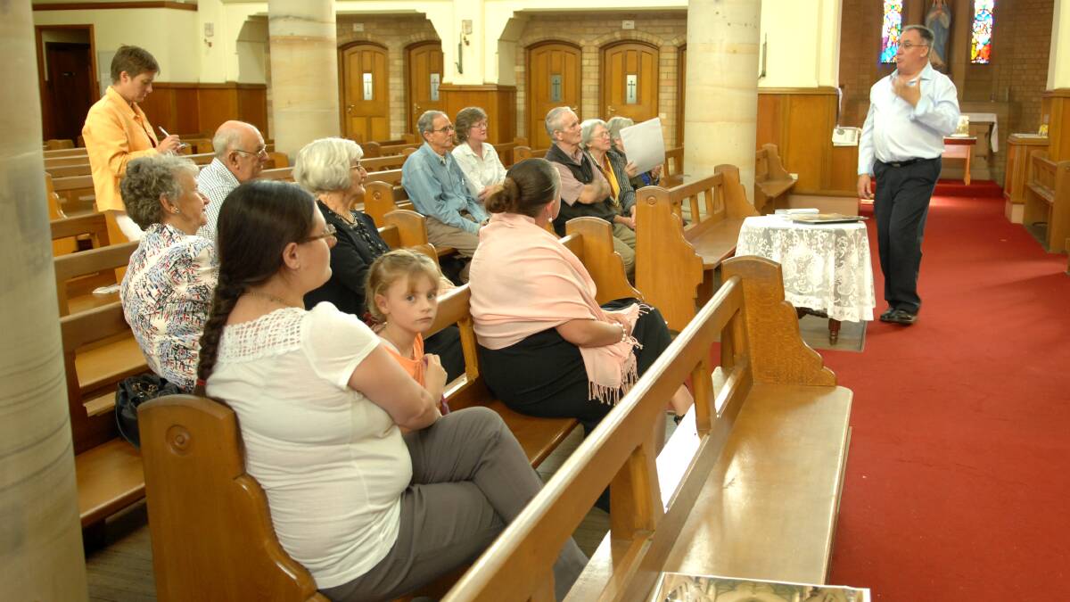 HISTORY BUFFS: Catholic Diocese of Bathurst vice chancellor Tony Eviston guided history buffs on a tour of the hidden treasures at the Cathedral of St Michael and St John yesterday. 
Photo: ZENIO LAPKA 	031614zcathedral