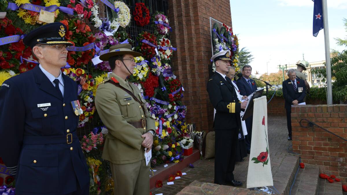 HUMBLING: Rear Admiral Tony Dalton delivers the commemoration address, joined by David Scheul and Andrew Matthews. Photo: PHILL MURRAY 	042515panzac28