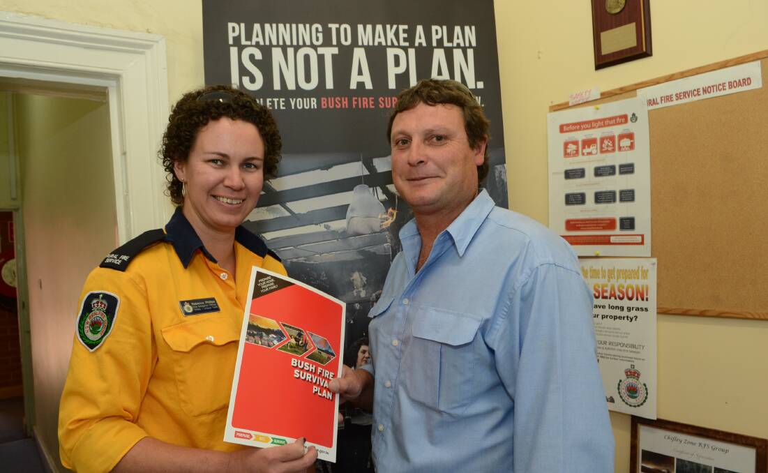 PLAN NOW: With temperatures set to soar and a very high fire danger forecast for Bathurst, NSW Rural Fire Service Chifley Zone fire mitigation officer Rebecca Phillips talks bushfire survival plans with Tony Gunning. Photo: PHILL MURRAY	 112014pfire