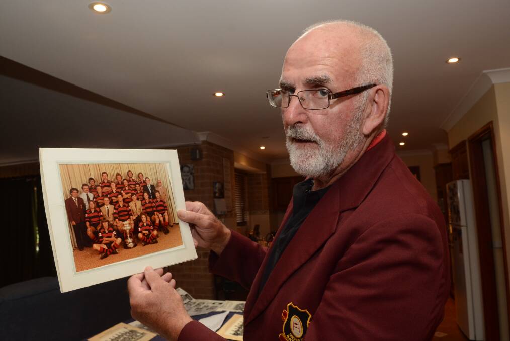 REUNION: Tex Stevens with a picture of Charlestons’ 1967 premiership winning team. 	012116ptex