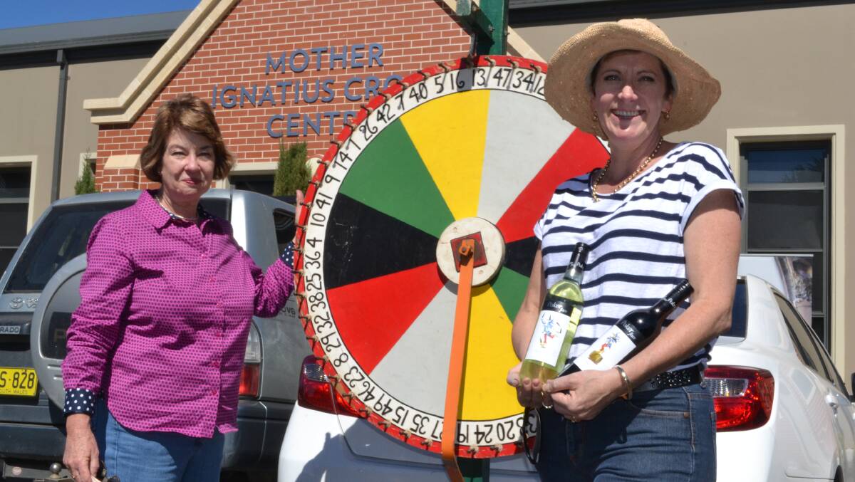 SPIN TO WIN: Cathedral Parish Fete organisers Margaret Gibson and Leonie Keogh said the chocolate wheel was a hit with people at Saturday’s Cathedral Parish Fete. Photo: NADINE MORTON	 032815nmvote13
