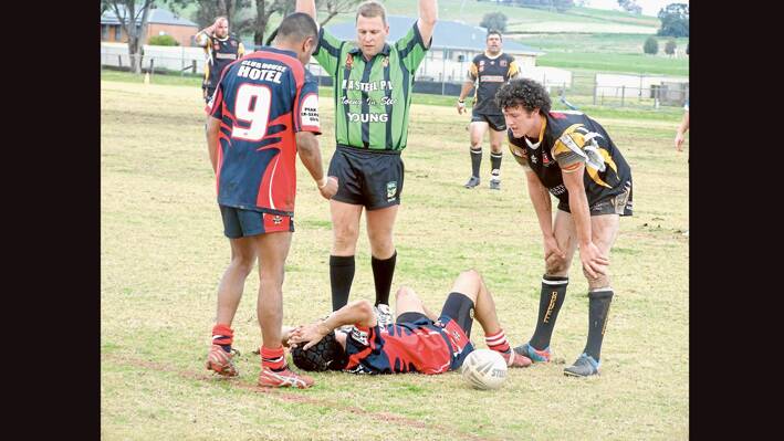 Showing the pressure of the hard contest in last week's Goannas vs Peak Hill match at Lawson Park last Sunday - a Peak Hill player takes his time to return to the fray as the ref calls a temporary halt while Goannas Brendan Hewen, marker Dylan Whiting and forward Chris Dixon look on. 
