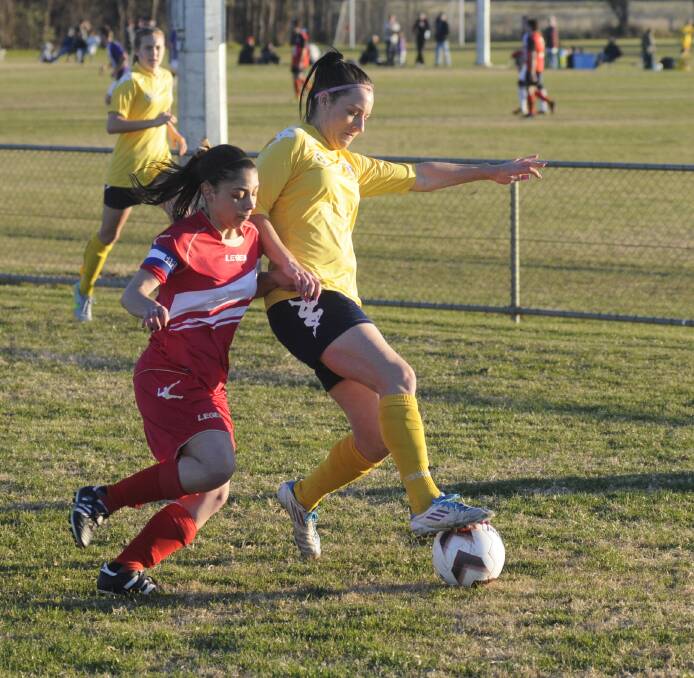 SCRAPPY: Natasha Portelli (left) from Parramatta and Kristy Collingridge from the Western NSW Mariners FC do battle for possession in the Mariners’ 2-0 win on Sunday. Photo: CHRIS SEABROOK	 062815cmarin1