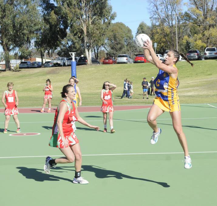 TOP THREE: Darcie Morrison (right) from the Bathurst opens team in action at the Bathurst carnival on Sunday. Their side went on to finish third in their division, which was taken out by the Bathurst under 21s representative team. Photo: CHRIS SEABROOK 	052916cnetball1
