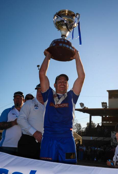 WE MEET AGAIN: St Pat’s captain Mick Armstrong raises the Group 10 trophy after the Saints beat Cowra in last year’s grand final. The two will meet for the first time in 2015 tomorrow.