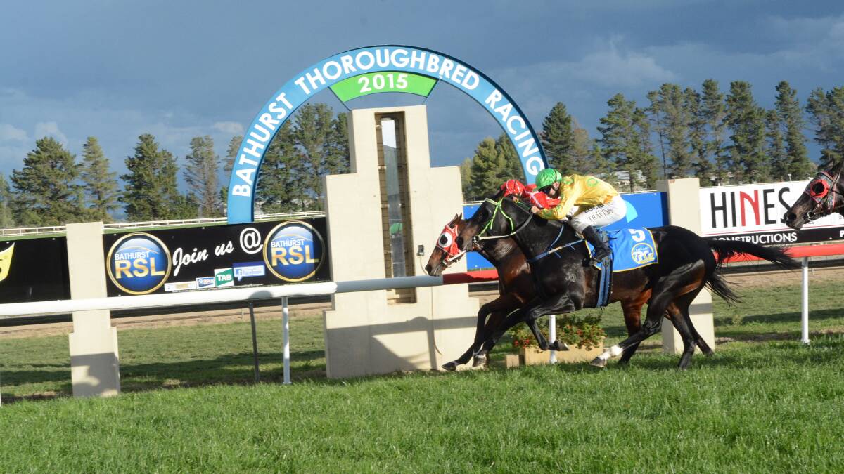 TIGHT FINISH: Greg Ryan rides Prattler (inside) to victory in Saturday’s Soldier’s Saddle for Dubbo trainer Justin Stanley. The runner-up, Hollywood Nell, is trained in Bathurst by Stanley’s father Peter. Photo: PHILL MURRAY 	042515prace2