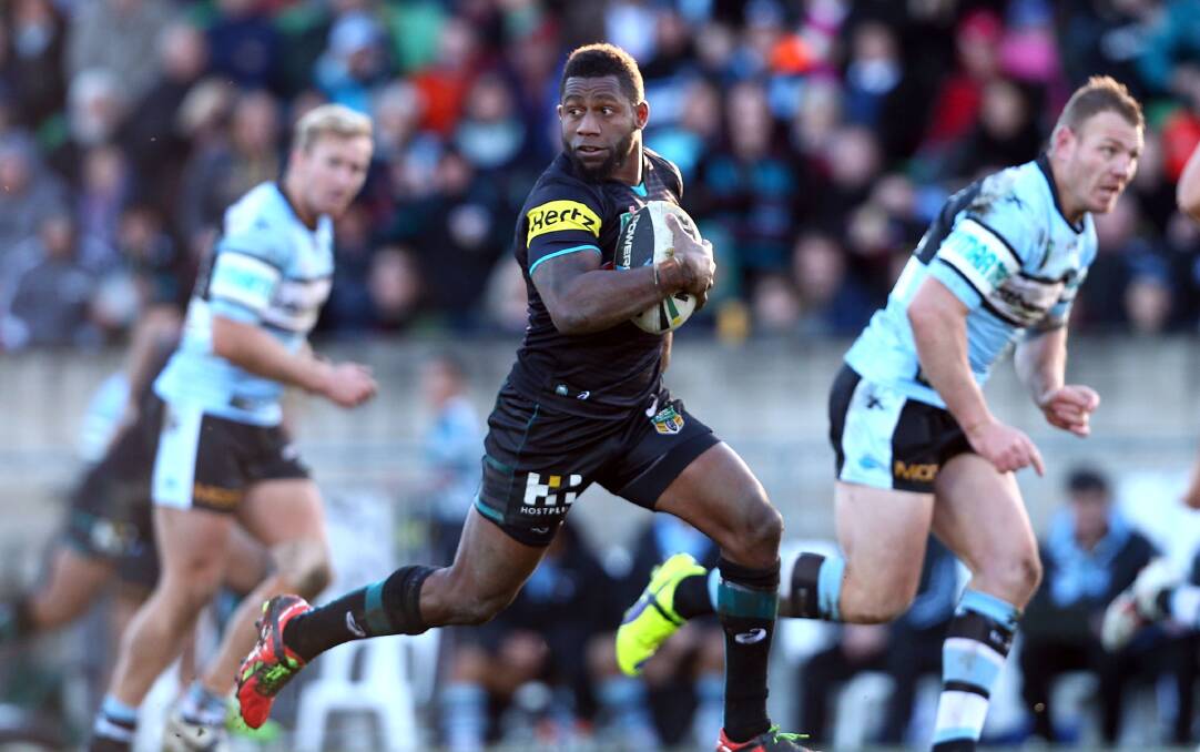 DANGER: Panthers hooker James Segeyaro breaks Cronulla’s defensive line at Carrington Park last year. Today when he makes his return to Bathurst he will be looking to cause the Gold Coast Titans plenty of headaches. Photo: GETTY IMAGES 	031315segeyaro