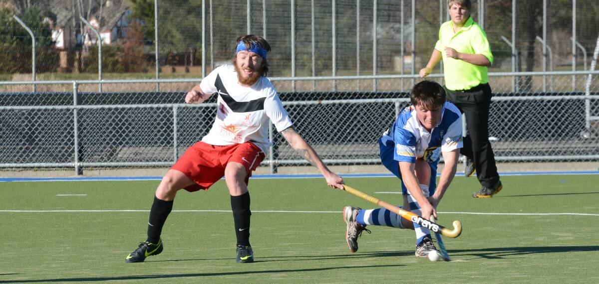 ANOTHER WIN: Pat’s player Josh Toole (right) contends for the ball in Saturday’s 6-2 win over Parkes United at the Cooke Hockey Complex. Photo: PHILL MURRAY 	062114ppats12