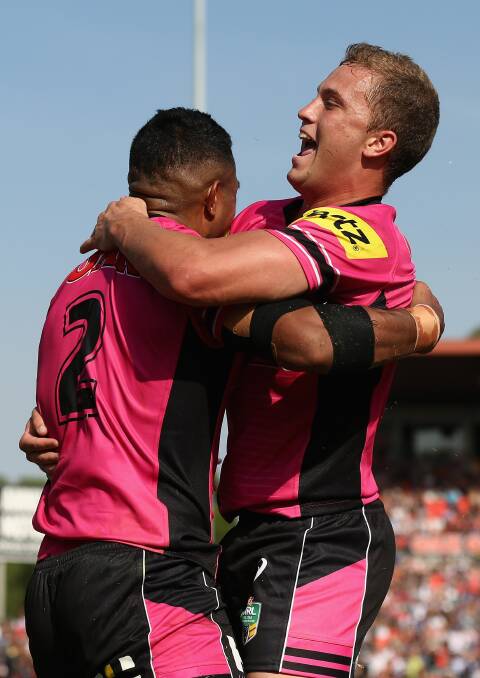 YOUNG TALENT TIME: Panthers fullback Matt Moylan (right) embraces George Jennings after the winger scored in last Sunday’s season opener. The two rising stars have been named in Penrith’s side to play at Carrington Park tomorrow. Photo: GETTY IMAGES 	031215moylan