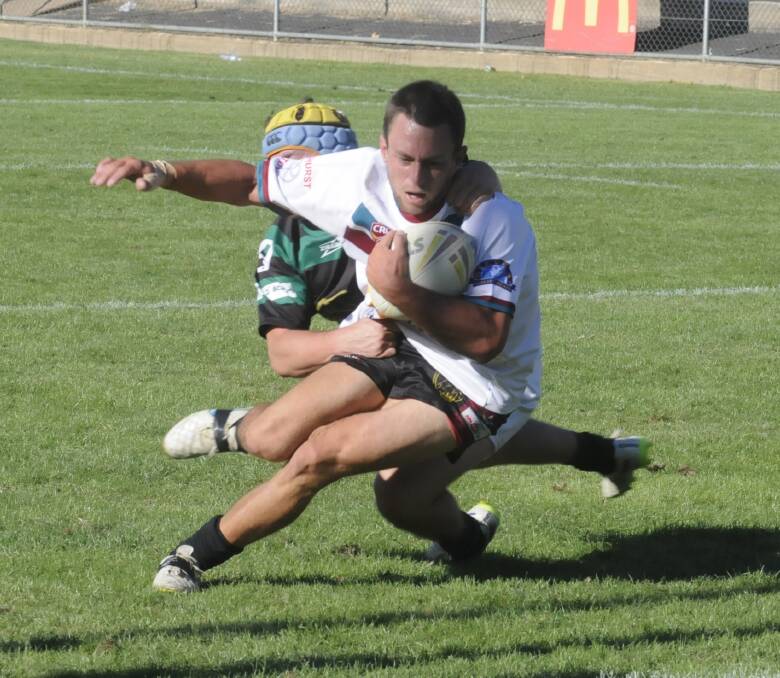 WHAT A WIN: Bathurst Panthers’ Nick Loader loosens himself from the grip of Orange CYMS’ Sam Hill to dive over for his side’s opening try in their 38-6 Bathurst Panthers Knockout premier league final victory on Saturday. Photo: CHRIS SEABROOK 	031916pan1a