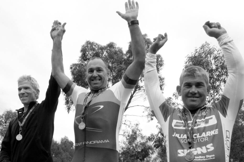 GREAT WIN: Charlie Gascoyne (centre) after picking up a gold medal at the NSW Masters Cycling Championships. 	050416charlie