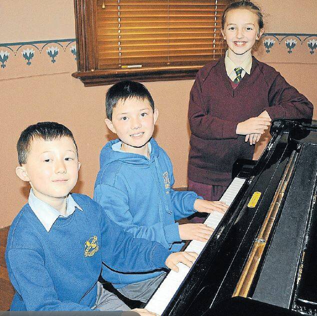 MAKING MUSIC: Piano students, brothers Xavier, 8, and Zachary Haynes, 11, join Nadia Day-Hakker, 9, in getting ready for the 2014 Bathurst Eisteddfod. ON THE COVER: Nadia Day-Hakker. Photos: CHRIS SEABROOK 081814ceist2, 1a