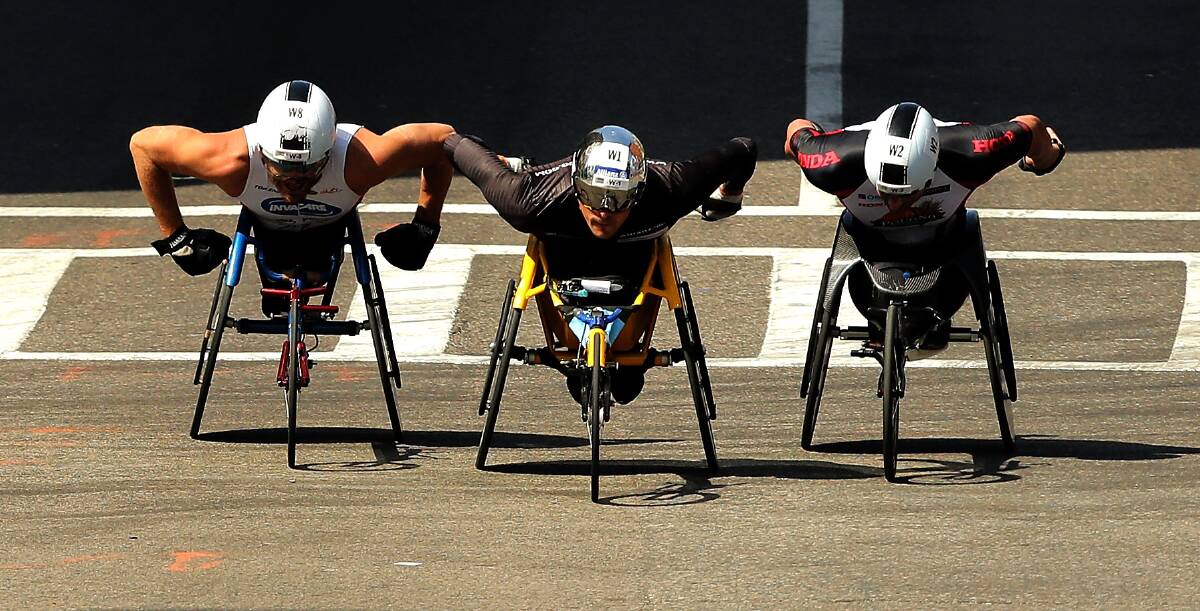 TIGHT FINISH: From left, Kurt Fearnley, Marcel Hug and Ernst Van Dyk race down Boylston street during the final stages of 120th Boston Marathon. In the end Fearnley placed third. Photo: GETTY IMAGES 	041816kurt