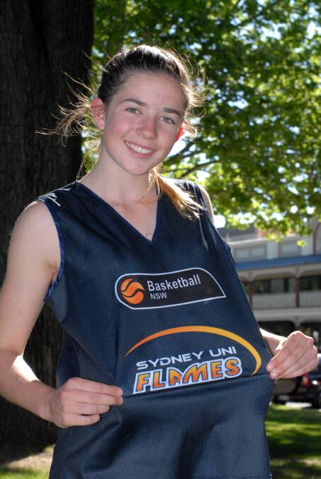 NEW COLOURS: Emily Matthews shows off some of her Sydney Flames attire after being included in a Flames development program recently. Photo: ZENIO LAPKA 	103014zmatthews1
