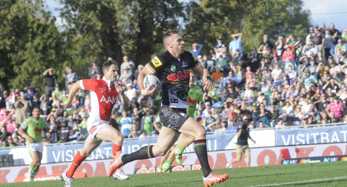 WHAT A FINISH: Bryce Cartwright runs away for the first of the Penrith Panthers' three tries in their thrilling 19-18 win over the Canberra Raiders at Carrington Park on Saturday. Photo: CHRIS SEABROOK 043016cnrl2