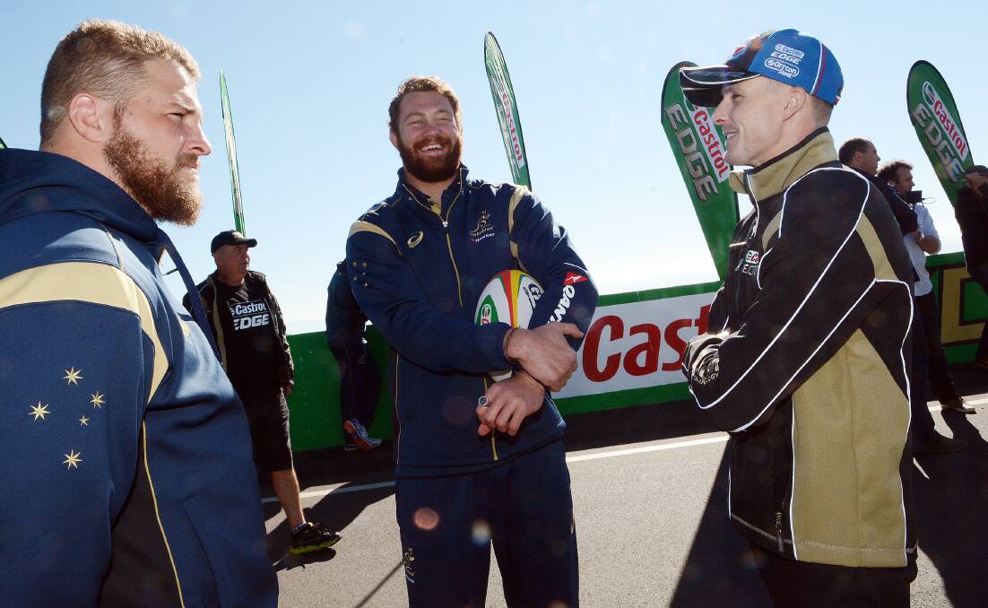 COOL HEAD: Hooker James Slipper (left), along with Wallabies team-mate Scott Higginbotham and V8 Supercar driver Mark Winterbottom at Mount Panorama. Photo: PHILL MURRAY 	080614pcastrol11