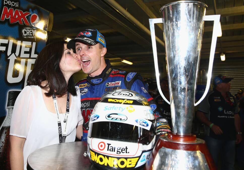 DOUBLE UP: Mark Winterbottom celebrates with his wife Renee after winning the 2013 Bathurst 1000. This year he hopes to notch up another Great Race win and continue his push towards a maiden V8 Supercars drivers’ championship. Photo: GETTY IMAGES 	090715winterbottom