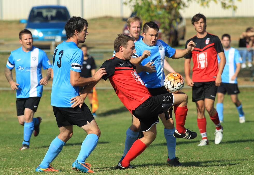 THRILLING WIN: Panorama FC’s Nikki Spice attempts to keep the ball away from two Bathurst City Colts opponents in his side’s 4-3 win at Proctor Park on Sunday. Photo: PHIL BLATCH 	040316pbsoccer4