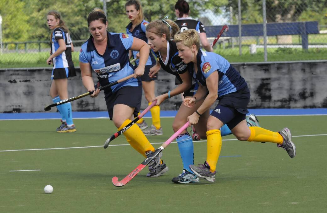 DESIRE: Souths duo Nikki Braun (left) and Ashleigh Corby race Zig Zag centre half Keely Hunter for the ball in Saturday's women's Premier League Hockey match. Photo: PHILL MURRAY 040514psouths12