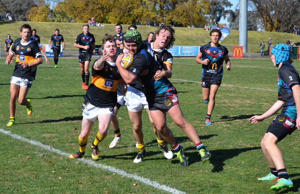 HERE IT COMES: Zac Burke drags two Oberon Tigers defenders with him on his way to scoring a try in Bathurst Panthers’ 26-4 win at Carrington Park on Sunday. Photo: ALEXANDER GRANT 	052415agpanu18s1