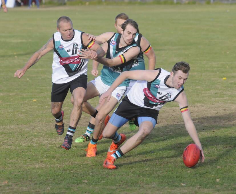 BUSHIES BATTLE: Joe Lemmich attempts to scoop the ball up for the Bathurst Bushrangers Rebels against the Outlaws in Saturday’s derby game. Photo: CHRIS SEABROOK 	052816cafl2