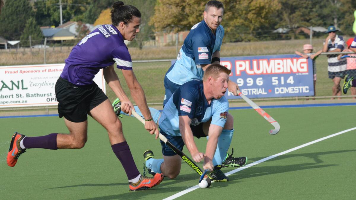 PRESSURE: Souths defender Andy Cranston tries to halt the run of Panthers rival Taylor Dobel in Saturday's men's Premier League Hockey match. Photo: PHILL MURRAY 041616psouths6
