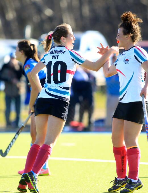 HIT THEN MISS: Bathurst City's Kelly Baker (left) celebrates a goal on Saturday with an errant high-five with team-mate Danielle Fisher. Photo: PHIL BLATCH 	070415pbwomens4